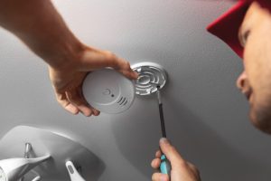 technician-installs-carbon-monoxide-alarm